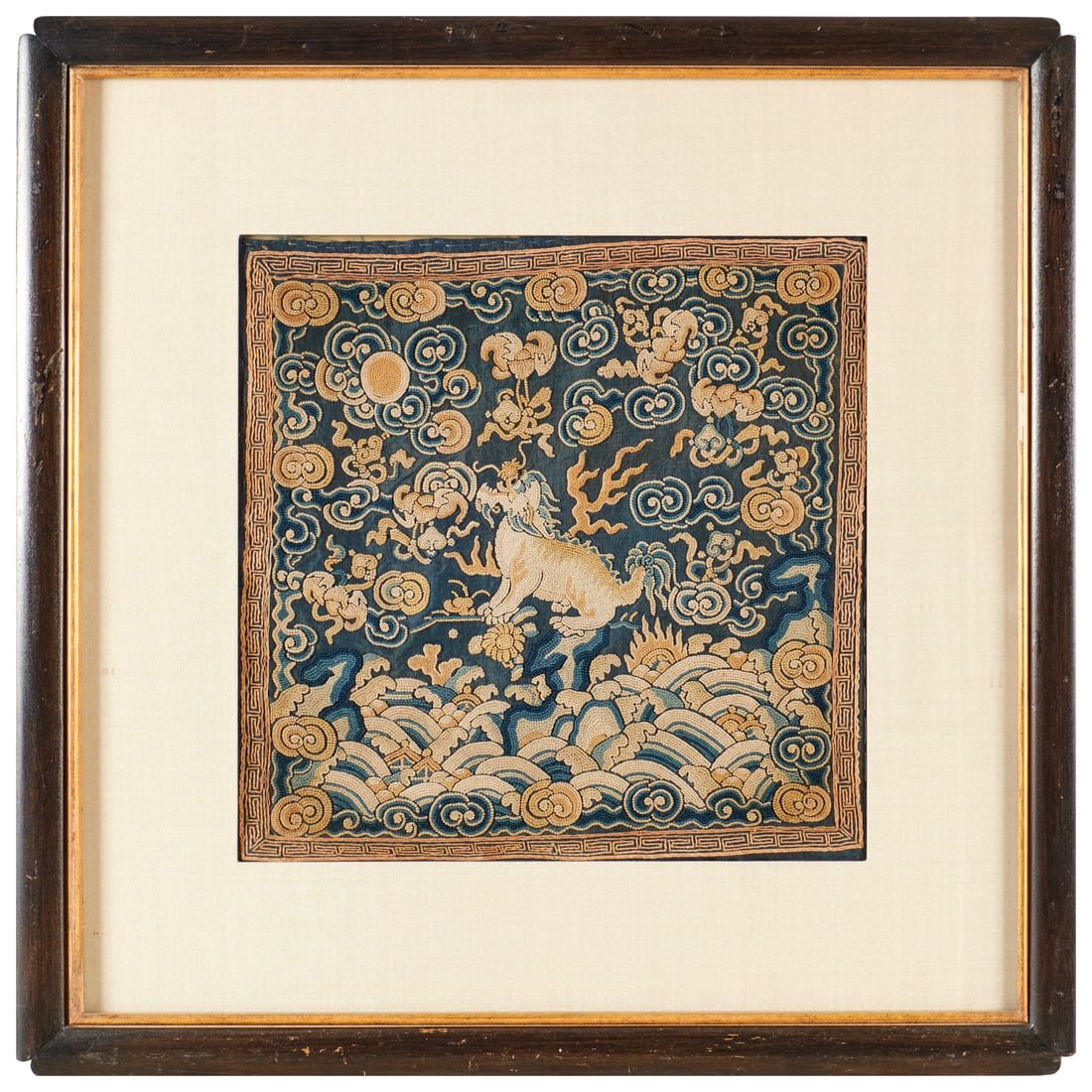 Chinese embroidered silk rank badge: Chinese embroidered silk rank badge, Qing Dynasty (19th/20th c.), silk and metallic thread, depicting a hsieh-chai (one-horned mythical creature), framed under glass, 12"squ (sight), 20.5"squ (frame)