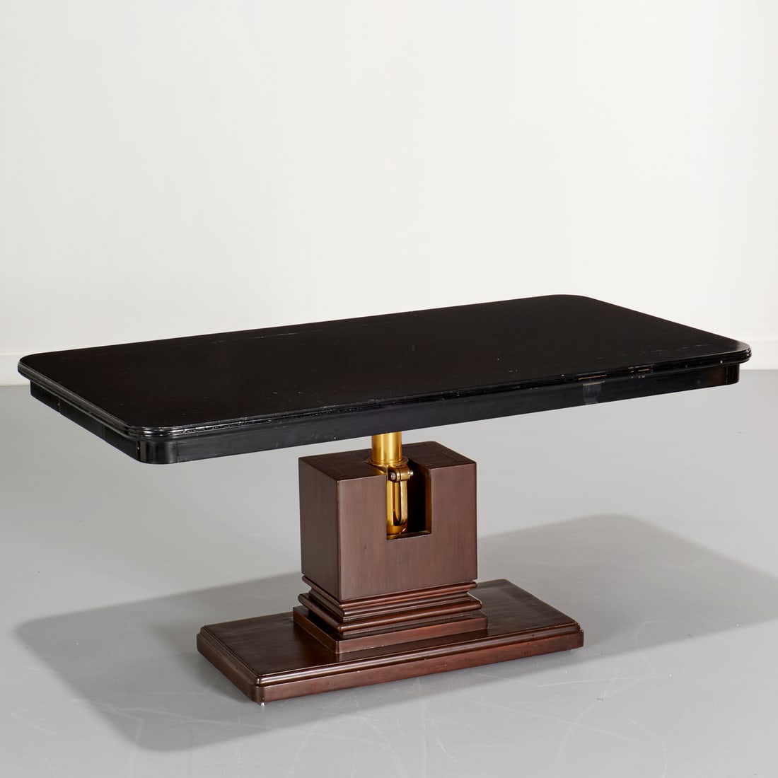 Otto Wretling (style) telescopic coffee table: Otto Wretling (style) telescopic coffee table, 20th c., black lacquered rectangular top, on adjustable pedestal base with mahogany finish, unmarked, 24.75"h (tallest) x 51.5"l x 26.5"w Provenance: A