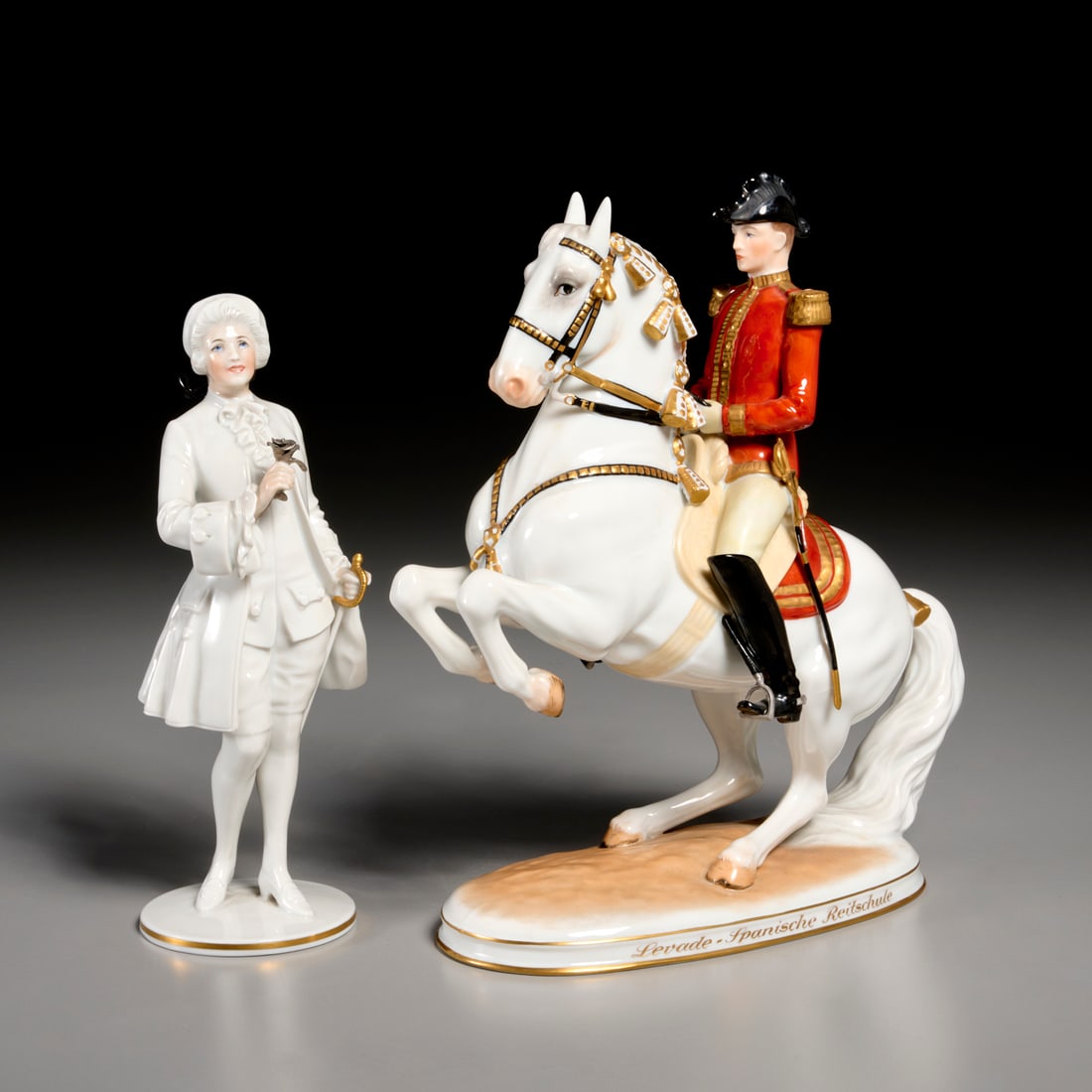 (2) Royal Vienna porcelain figures: (2) Royal Vienna porcelain figures, 20th c., incl. "Levade - Spanische Reitschule" (Spanish Riding School) mounted soldier, and a gentleman holding a silver rose, each marked underneath, 9.25"h x 8.25