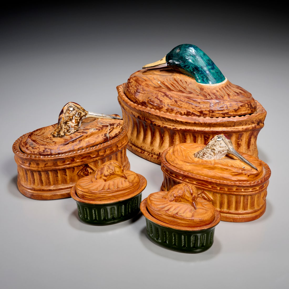 Group French porcelain covered casserole dishes: Group French porcelain covered casserole dishes, 20th c., assorted sizes, with duck and bird head lids, incl. (3) Pillivuyt, (1) Lamalle, and (1) unmarked, 7.5"h x 10"l x 6.5"w (largest), 3.5"h x 4.5"