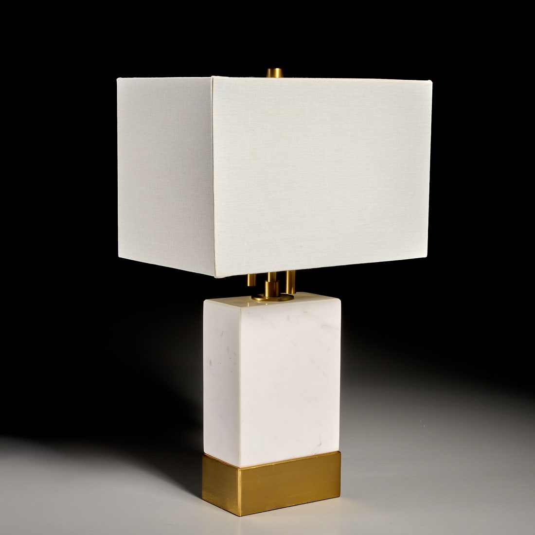 Contemporary designer marble table lamp: Contemporary designer marble table lamp, 21st c., with goldtone metal mounts, unmarked, 20"h x 5.75"w x 3.25"d (total, excl. shade), 8"h x 12"w x 8"d (shade) Provenance: The Collection of June and Fra