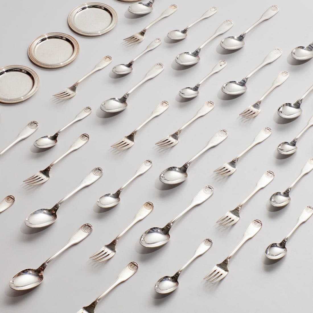 Christofle silver plated tableware, (48) pieces: Christofle silver plated tableware, (48) pieces, 20th c., France, incl. "Vendome" pattern, (14) soup spoons, 7.5"l, (9) teaspoons, (13) luncheon forks, and (12) coasters, 4"dia Provenance: A Private