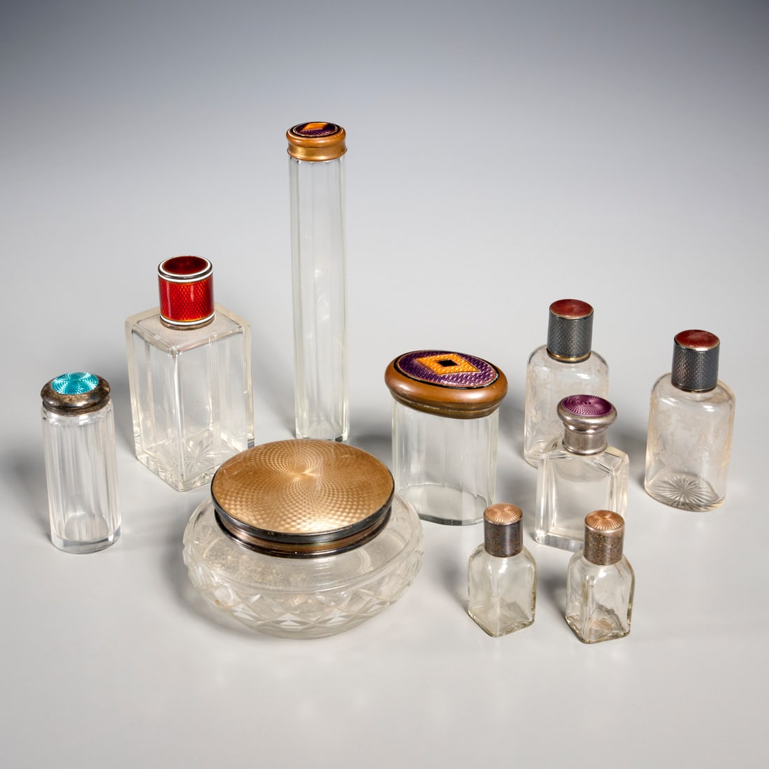Silver and guilloche enamel vanity group: Silver and guilloche enamel vanity group, 19th/20th c., primarily England and France, (10) pieces, incl. bottles and powder jar, some sterling silver mounted and fully hallmarked, 6.5"h x 1"dia