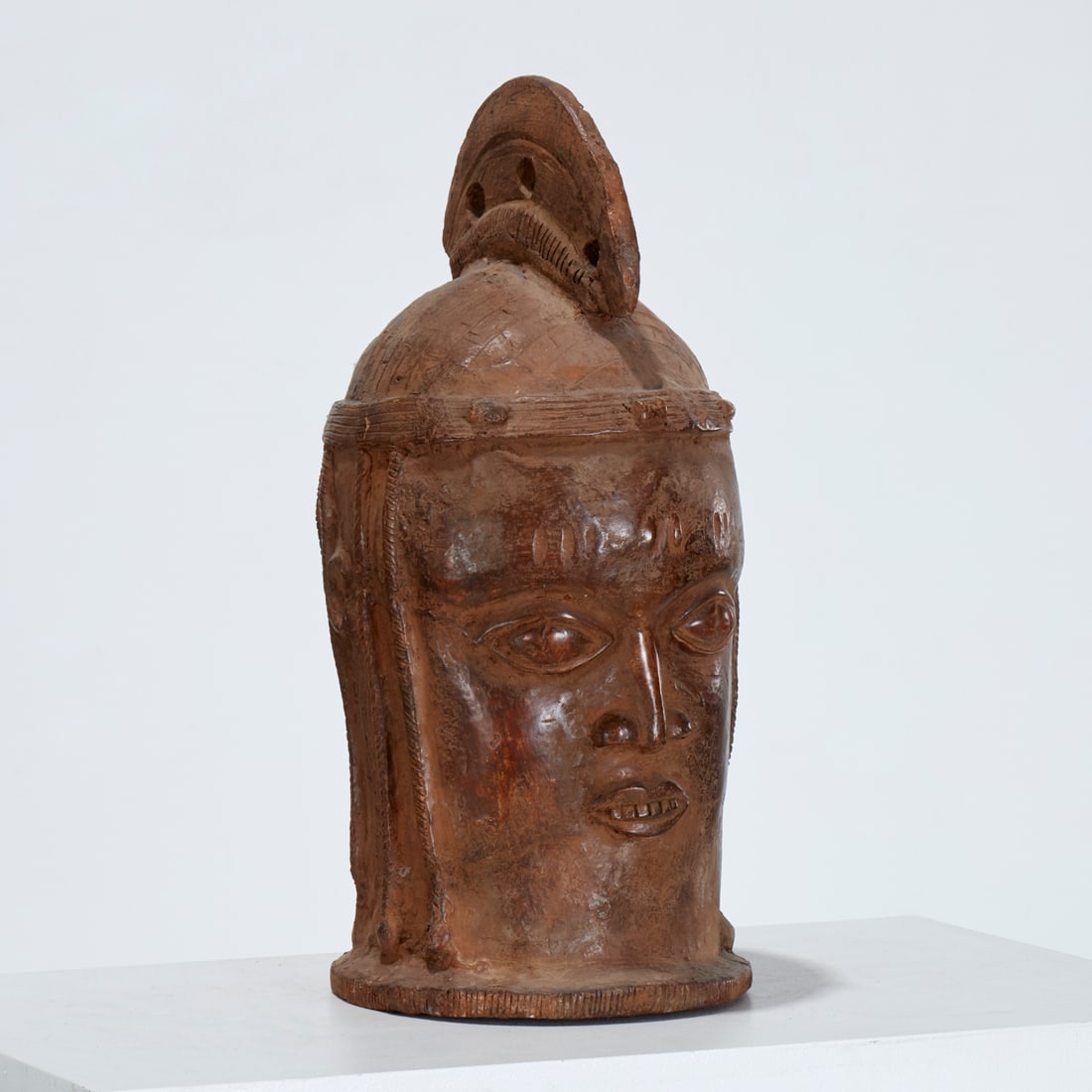 Large West African terracotta memorial head: Large West African terracotta memorial head, 20th c., possibly Benin, with crested headdress and burnished patina, 18.5"h x 8.5"w x 8"d