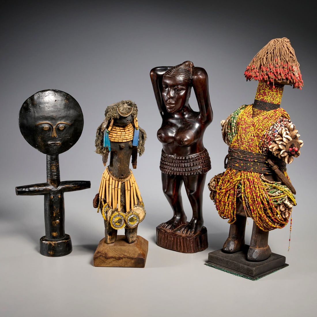 African carved figure group: African carved figure group, 20th c., (3) pieces, incl. a Fali beaded fertility doll, an Ashanti fertility figure, a Turkana fertility doll, and a standing female figure, 18"h x 8"w x 5.5"d (largest)