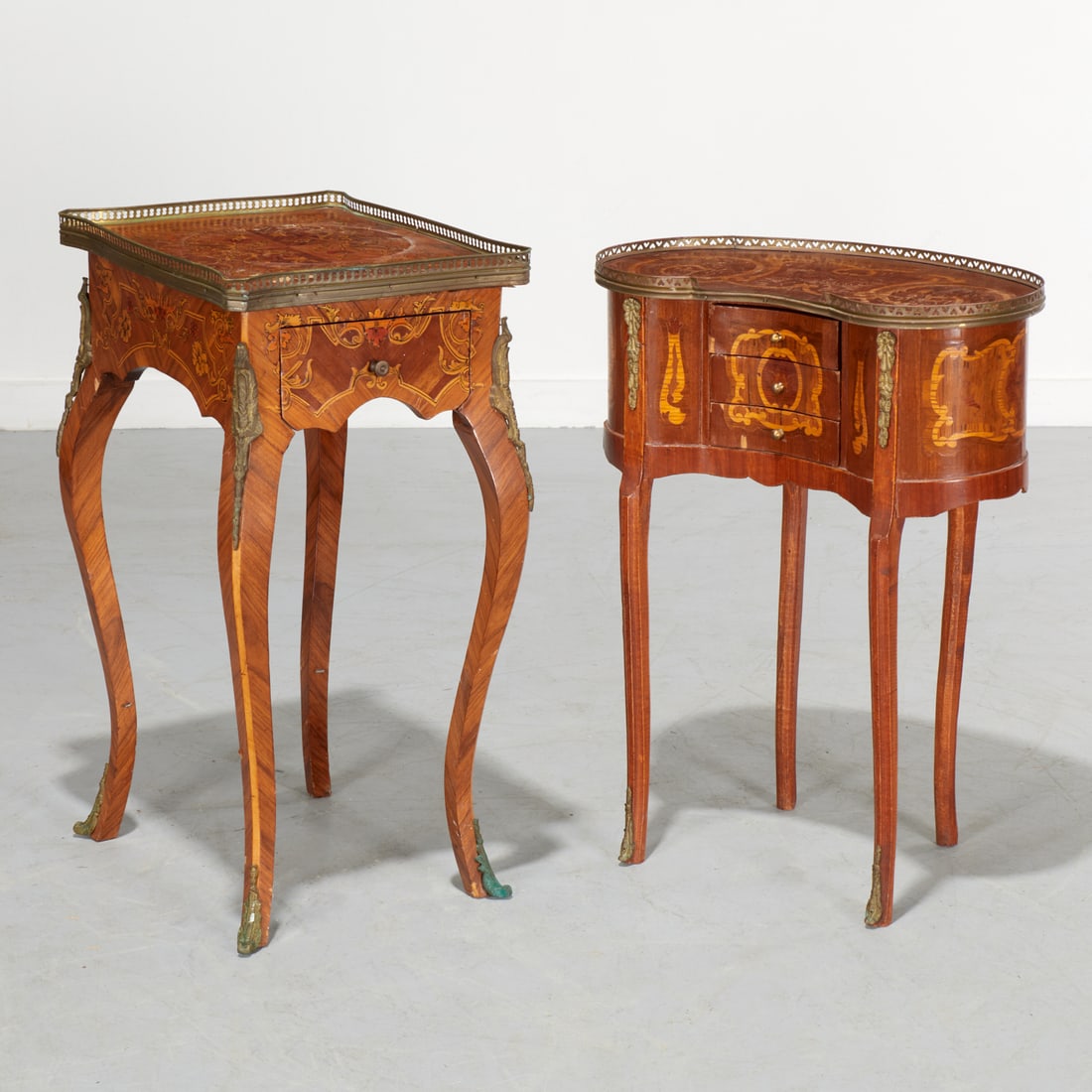 (2) Louis XV style marquetry side tables: (2) Louis XV style marquetry side tables, 20th c., floral and scroll decoration, each with pierced metal gallery top, gilt metal mounts and sabots, unmarked, 30.5"h x 19"w x 15"d (larger), 28.5"h x