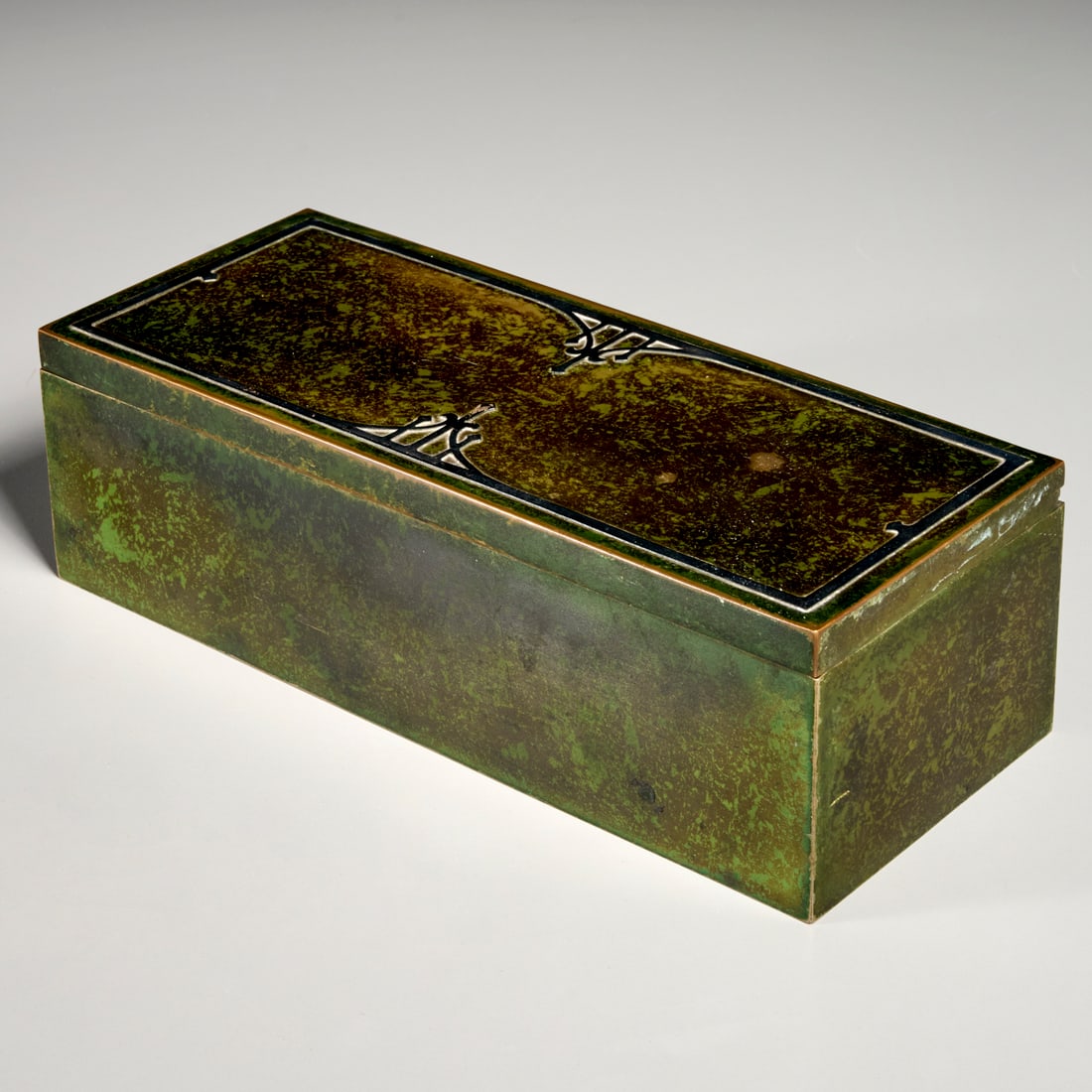 Heintz sterling silver on bronze cigar box: Heintz sterling silver on bronze cigar box, Early 20th c., USA, Arts & Crafts style, wood lining, Heintz Art Metal Shop stamp underneath, 2.5"h x 8.5"w x 3.5"d Provenance: The Estate of Camilla Dietz 
