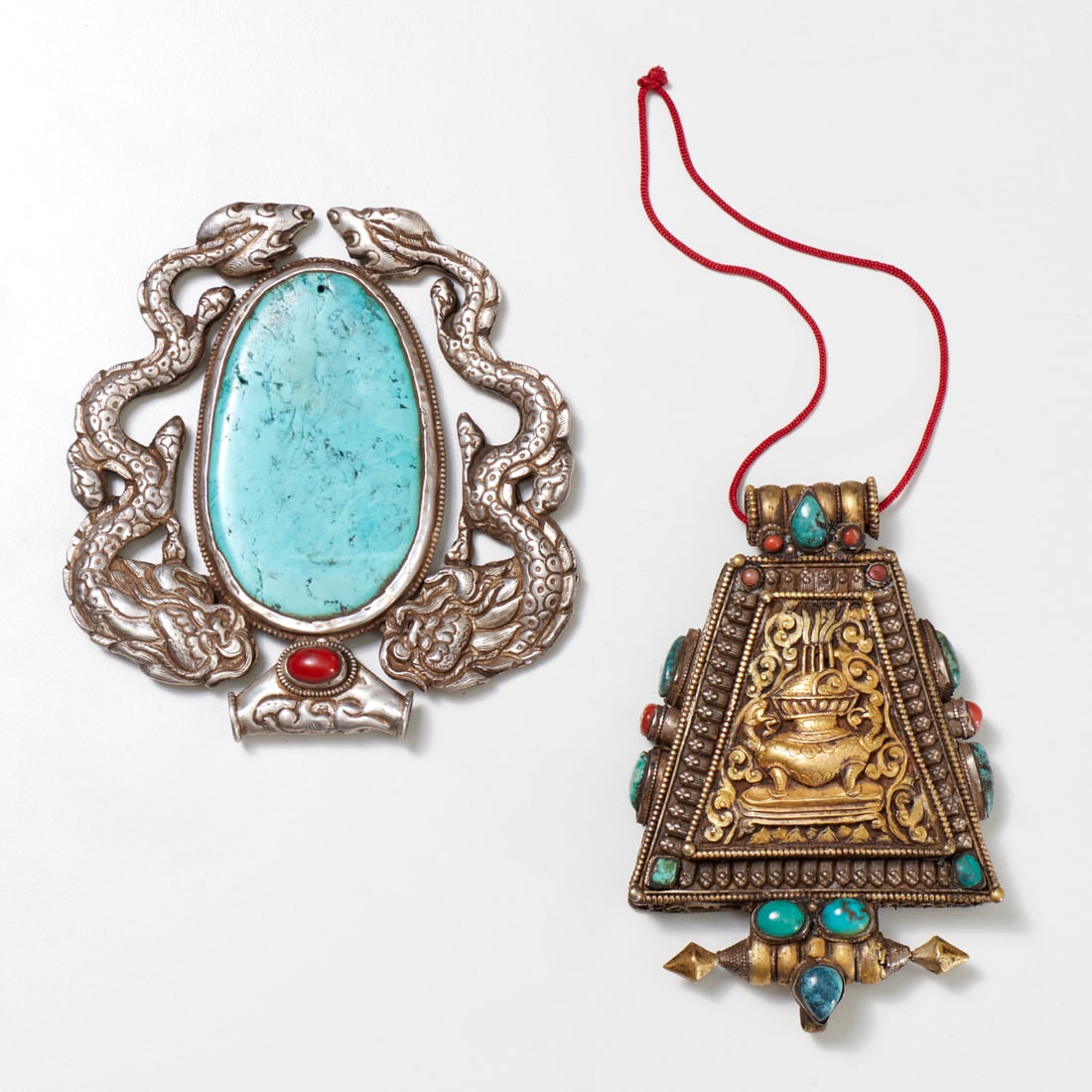 (2) Tibetan pendants, ex Iris Apfel: (2) Tibetan pendants, ex Iris Apfel, 19th/20th c., silver and goldtone metal, with turquoise and coral stones, incl. a Gau box pendant, and a double dragon pendant, 5"h x 4.75"w (larger), 5"h x 3.25"w