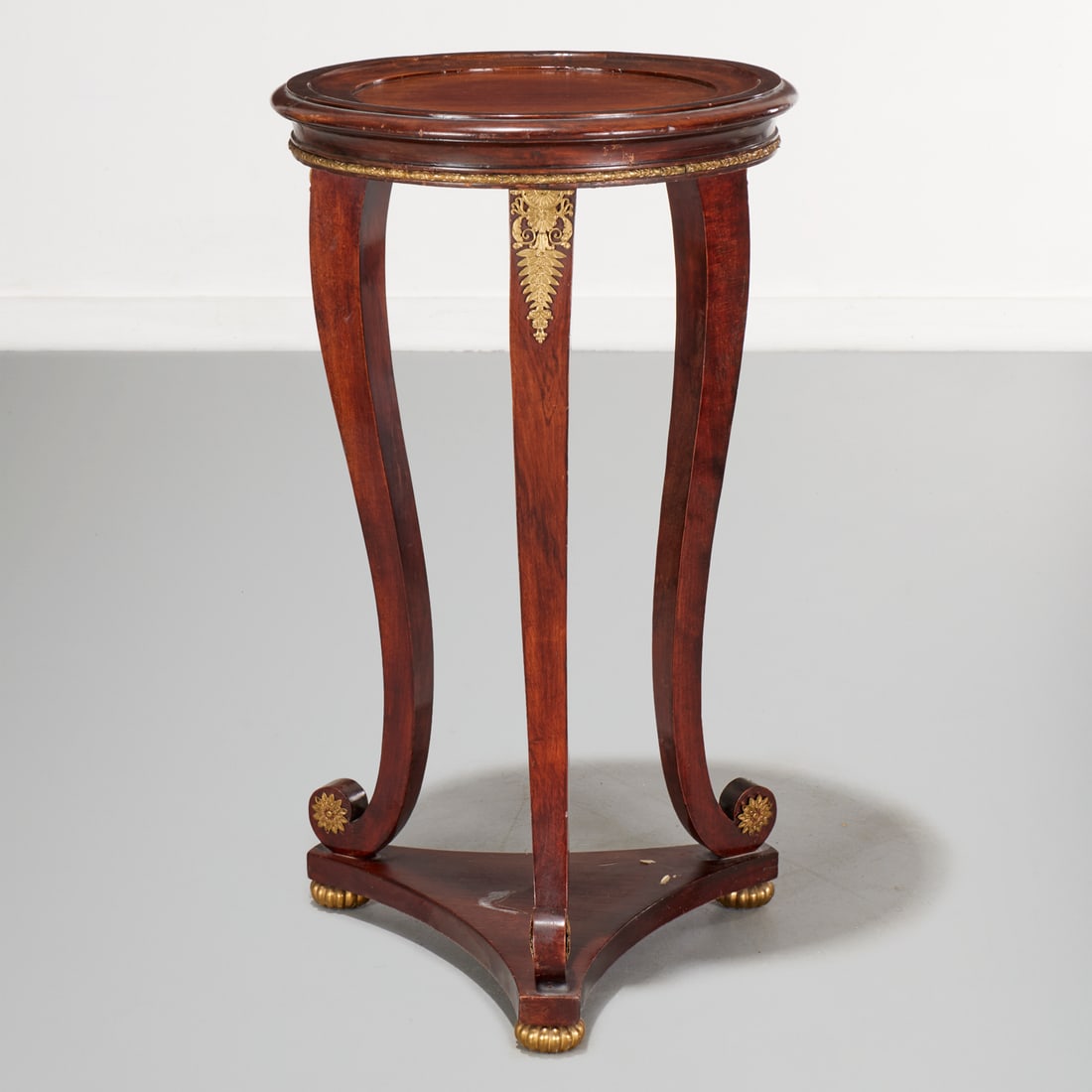 Empire style ormolu mounted mahogany gueridon: Empire style ormolu mounted mahogany gueridon, Early 20th c., circular top on tripod pedestal base, with metal mounts and trim, 33.5"h x 18.5"dia