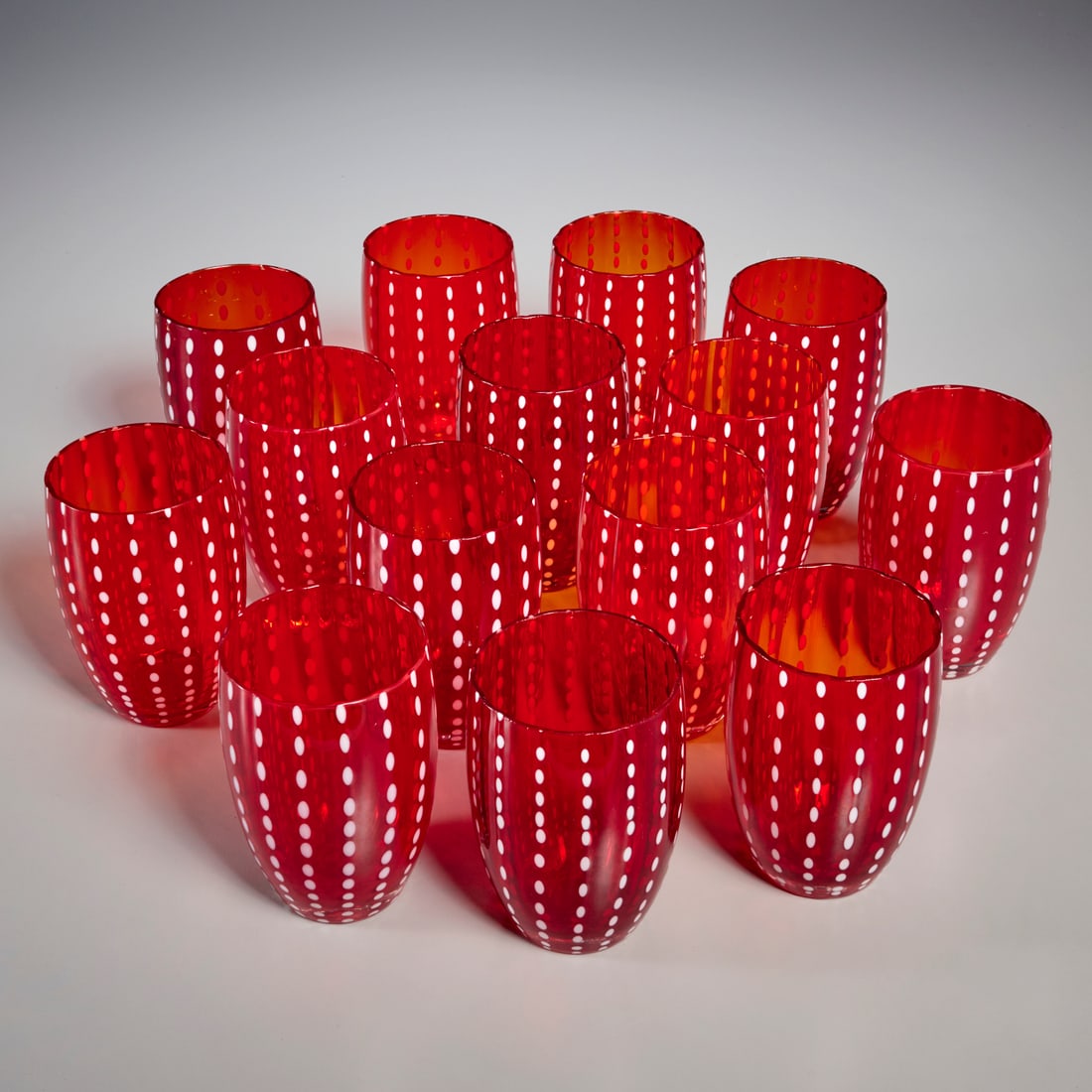 Set (14) Zafferano "Perle" red glass tumblers: Set (14) Zafferano "Perle" red glass tumblers, 21st c., designed by Federico de Majo, marked on underside, 4.5"h x 2.75"dia