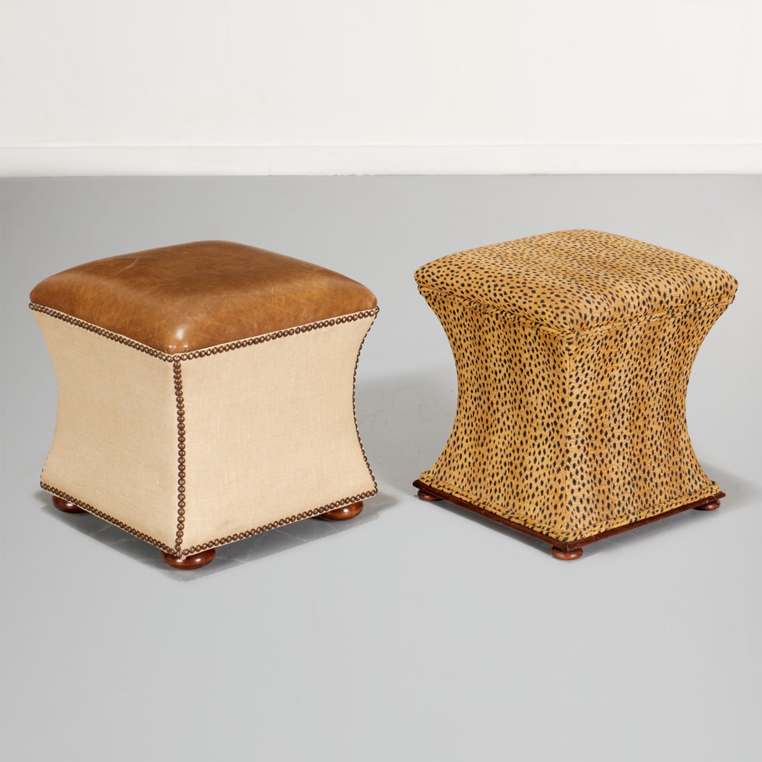 (2) Designer upholstered stools: (2) Designer upholstered stools, 21st c., incl. a leopard print storage ottoman, unmarked, and a leather top ottoman with nail head trim, marked "Owner's Select Furniture, NC", 17"h x 16.5"squ (larger