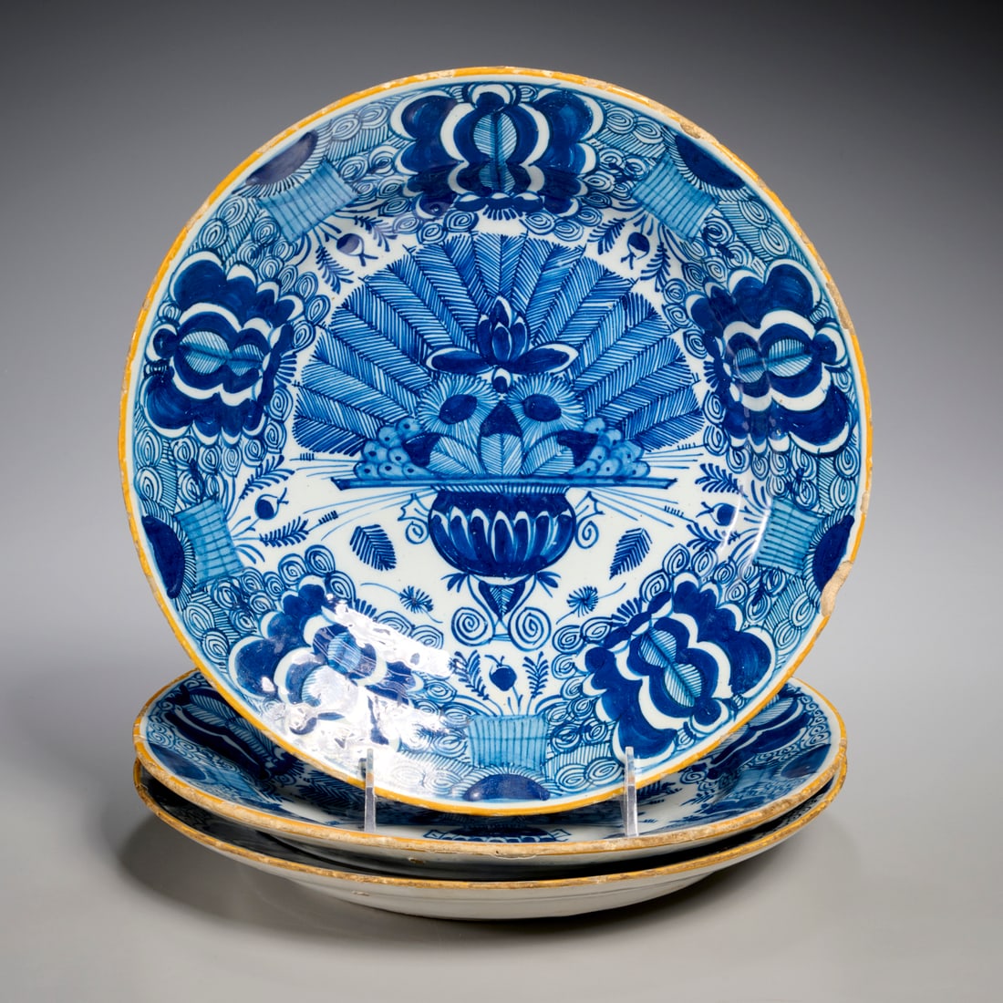 (3) Dutch Delft blue and white "Peacock" plates: (3) Dutch Delft blue and white "Peacock" plates, 18th c., ochre rim, cobalt blue decoration of peacock feathers and flowers, each marked underneath, 10.25-10.5"dia