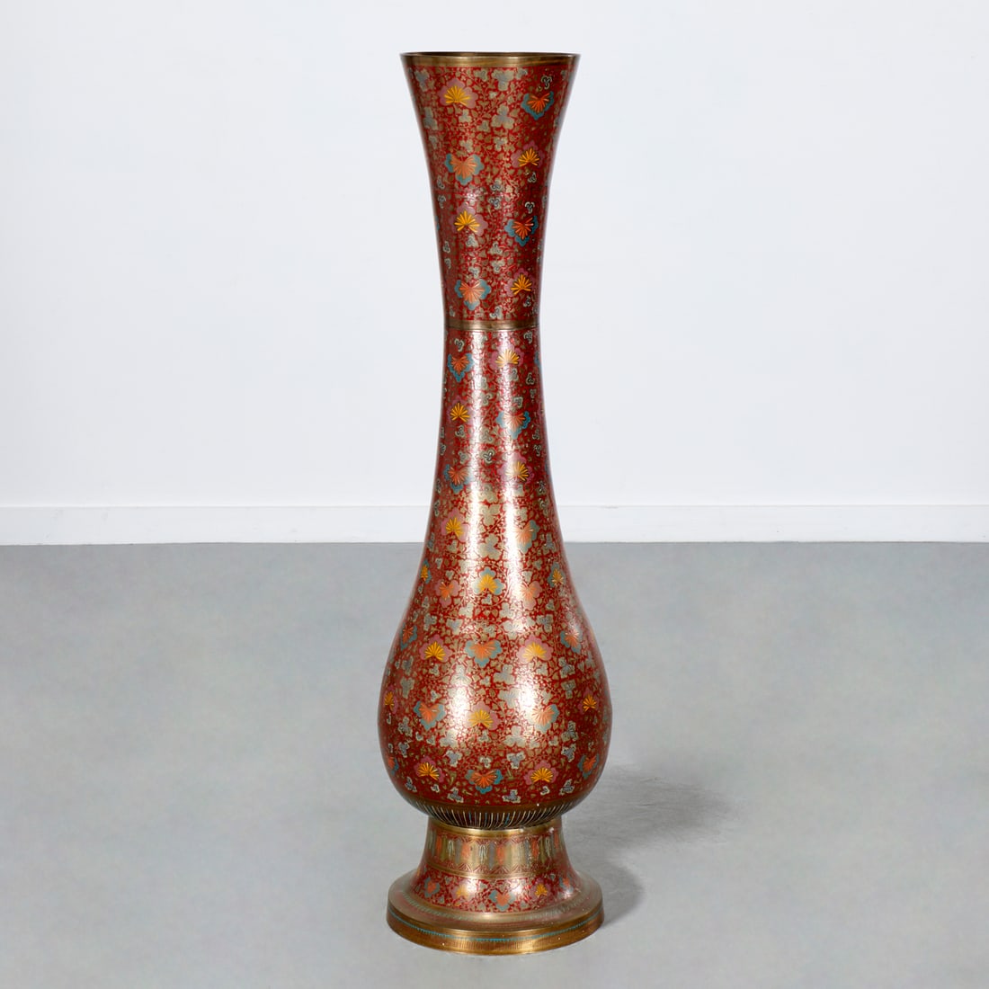 Large Indian enameled brass floor vase: Large Indian enameled brass floor vase, 20th c., flowering vine design, "Made in India" sticker label to underside, 50.5"h x 13"w Provenance: A Private Collection: 22 Partridge Hill Lane, Greenwich,