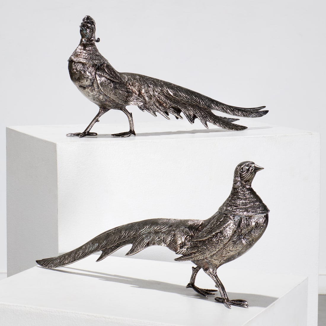Pair Italian silver plated table pheasants: Pair Italian silver plated table pheasants, 20th c., stamped "Italy" under foot, 10.5"h x 21"l x 3.5"w (larger), 9.5"h x 20"l x 3.25"w (smaller) Provenance: A Private Collection: 1095 Park Avenue, NYC