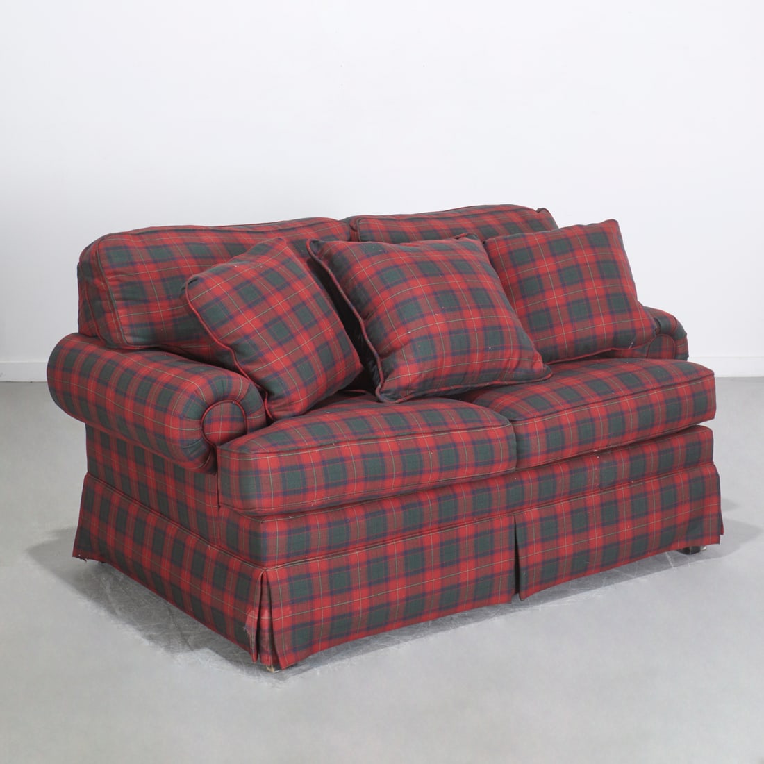 Taylor King tartan upholstered sofa: Taylor King tartan upholstered sofa, Late 20th/21st c., two seat sleeper sofa, Stuart tartan upholstery with down filled cushions, 38"h x 66"w x 39"d, 93"l (sleeper) Provenance: Property from a