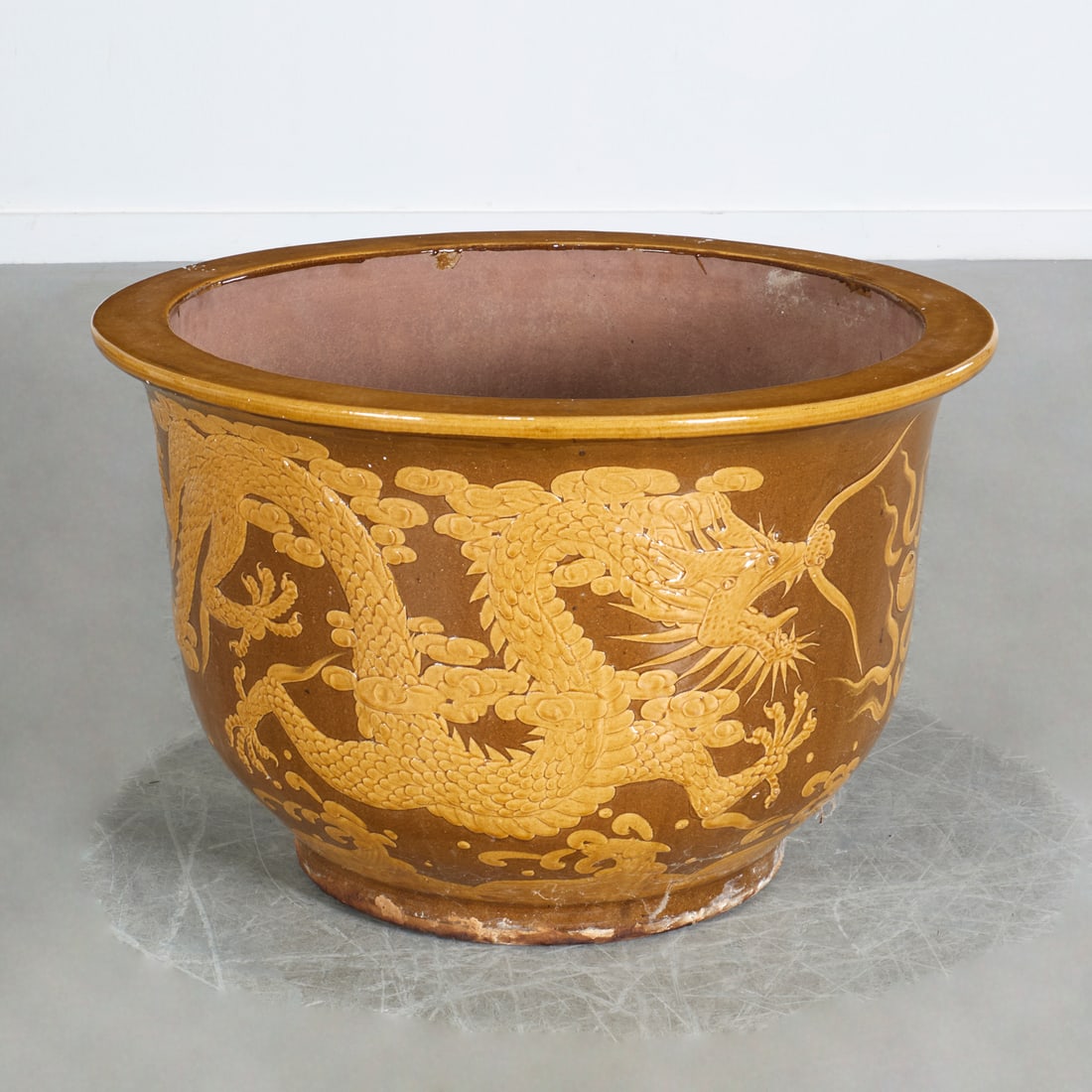 Large Chinese earthenware dragon jardiniere: Large Chinese earthenware dragon jardiniere, 20th c., brown glaze with yellow ochre Imperial dragon, unmarked, 20"h x 31.25"dia Provenance: A Private Collection: Beachside Avenue, Westport, CT