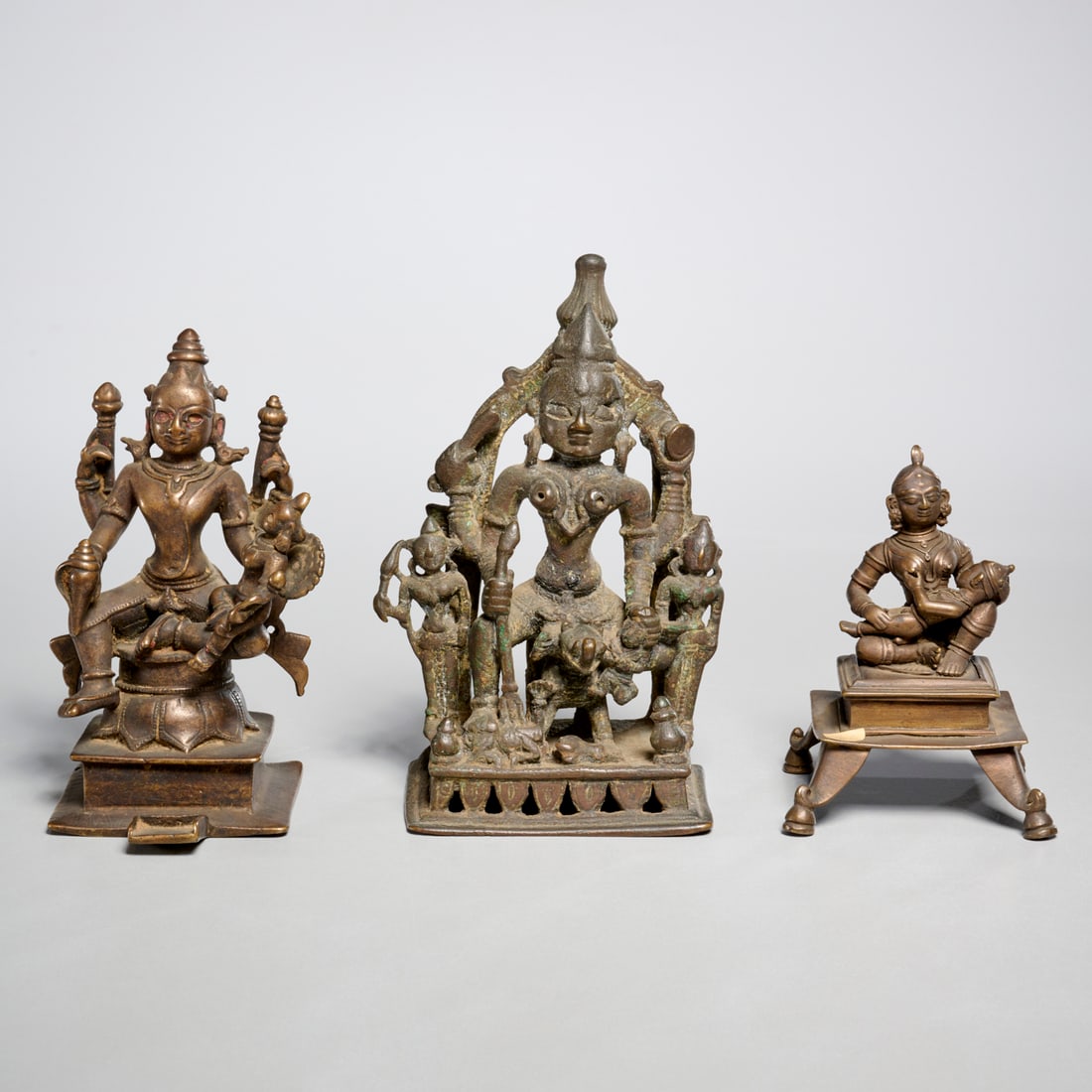 (3) Antique Hindu copper alloy altar figures: (3) Antique Hindu copper alloy altar figures, 17th c. and later, incl. Shiva, 7"h x 4.5"w x 2.75"d (largest), 4.75"h x 3.25"w x 3"d (smallest) Provenance: The Estate of Alexander Dobkin, NY