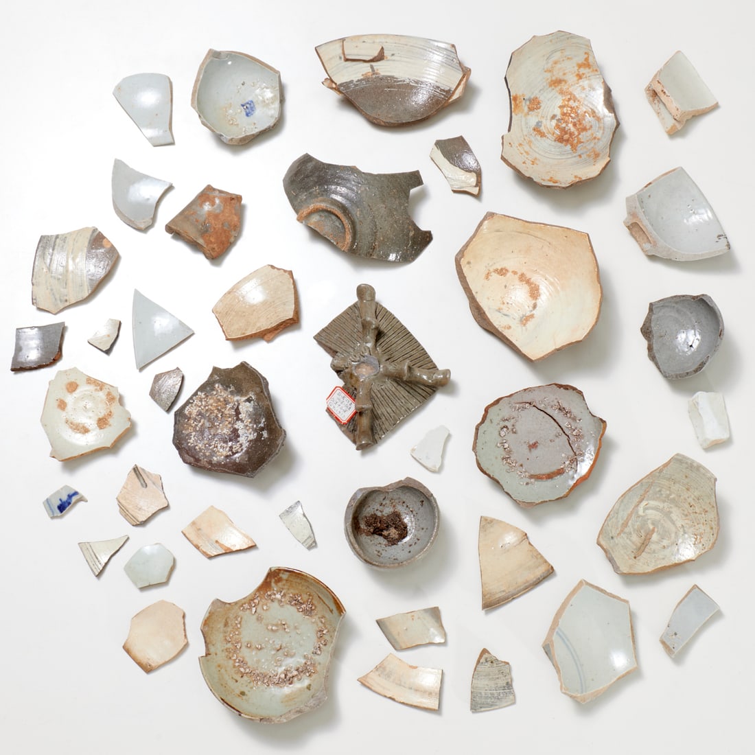 Asian pottery fragments and shards: Asian pottery fragments and shards, Some possibly Chinese Ming Dynasty / Korean Joseon Dynasty, (30+) fragments and shards, glazed earthenware fragments, some in celadon glaze, one piece with sticker 