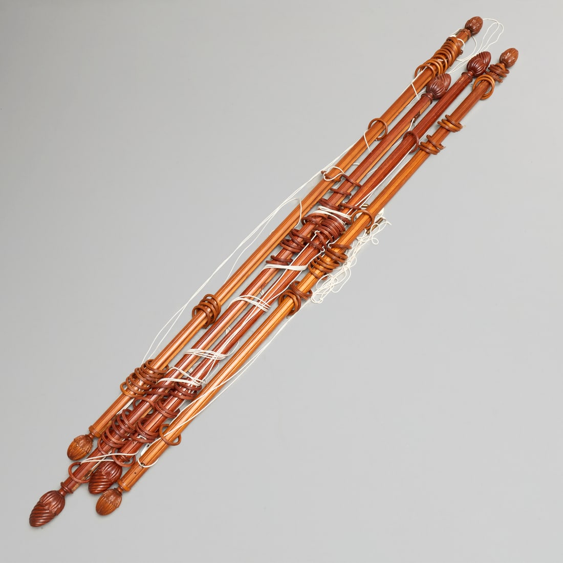Set (4) carved wood curtain rods: Set (4) carved wood curtain rods, 20th c., (2) pairs each with acorn finials, unmarked, approx 103"l (larger), 99"l (smaller)