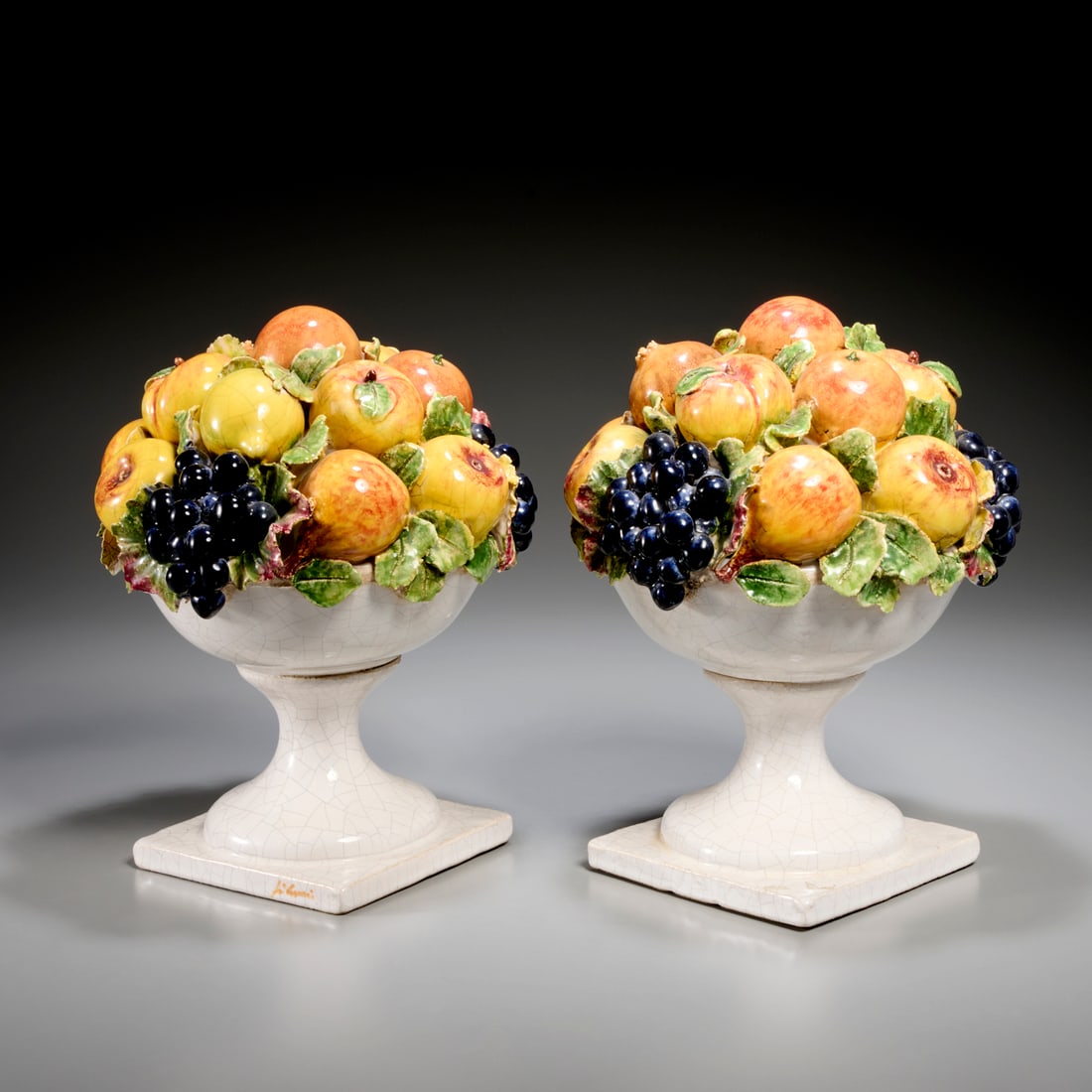 Pair Italian majolica fruit bowl centerpieces: Pair Italian majolica fruit bowl centerpieces, 20th c., Italy, glazed ceramic, illegible mark to side of base, 12.25"h x 10"dia Provenance: A Private Collection: 1095 Park Avenue, NYC