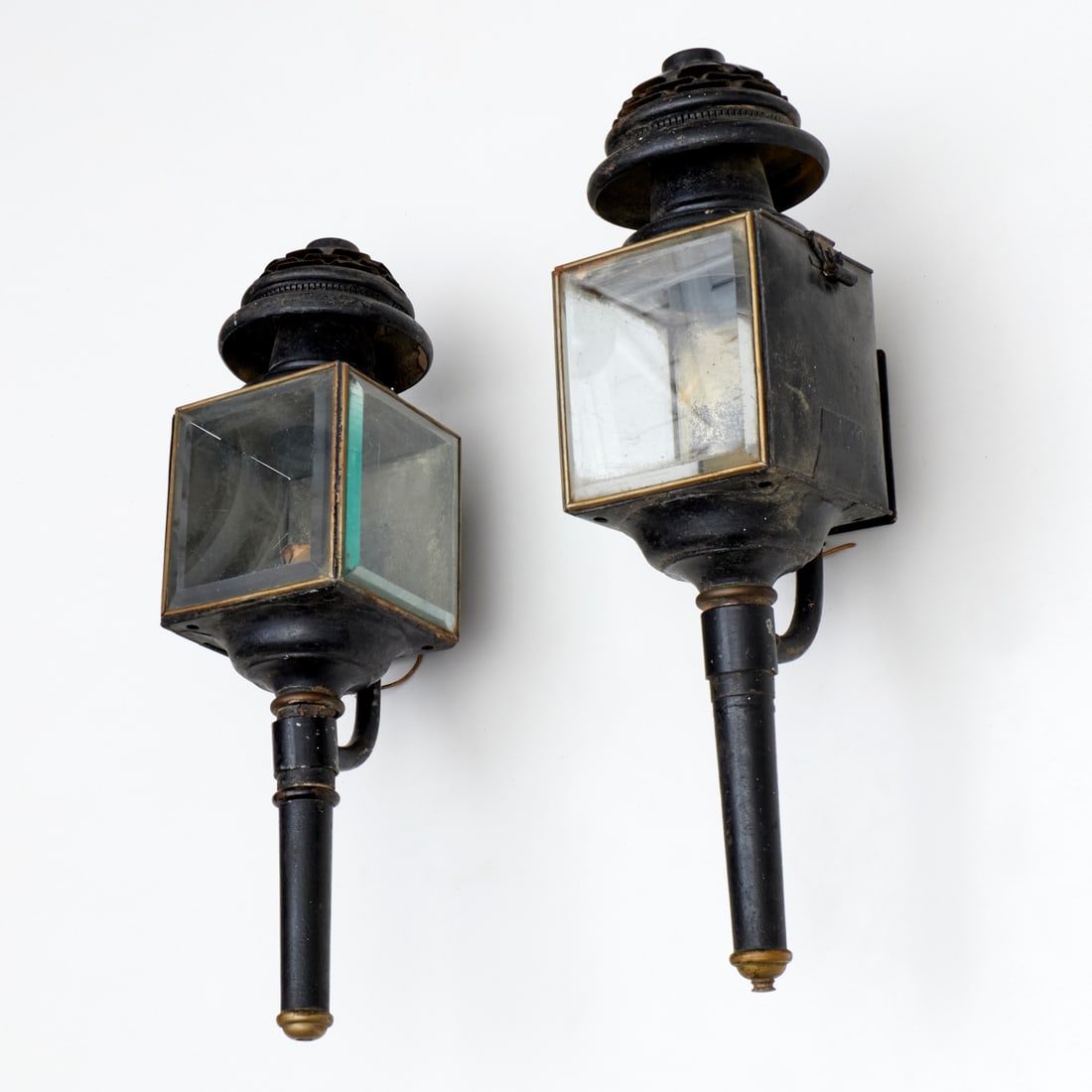Pair large antique iron and brass coach lights: Pair large antique iron and brass coach lights, 19th/20th c., each with two beveled glass panes, hinged door for accessing bulbs, with mounting brackets, 23"h x 5.5"squ (lanterns), 8.5"d from wall mou