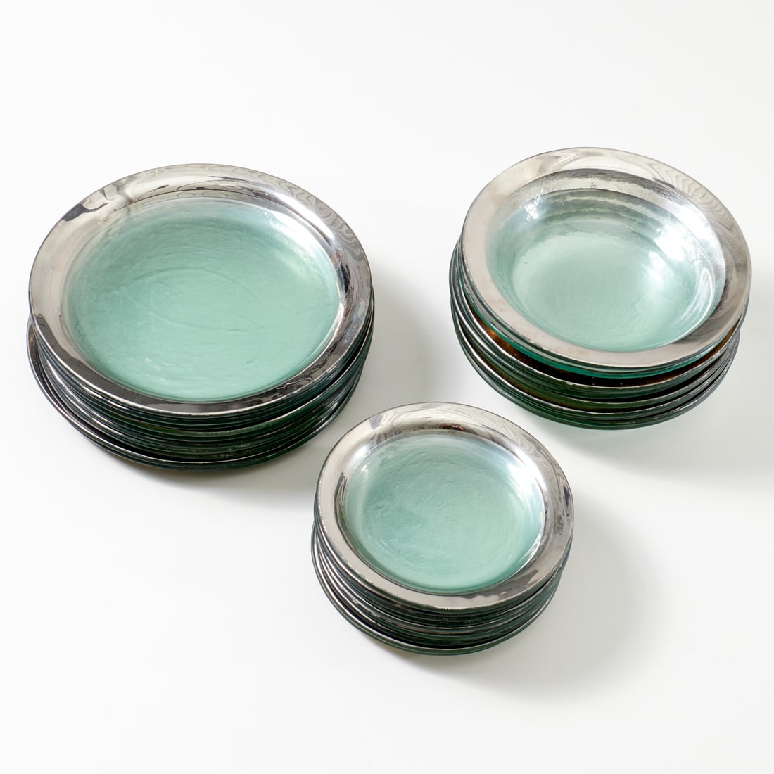 Annieglass, set plates and bowls: Annieglass, set plates and bowls, Late 20th c., (30) pieces, colorless glass with platinum rim, incl. (10) each: dinner plates, 10.25"dia, salad plates, 7.25"dia, and bowls, 8.75"dia, signed