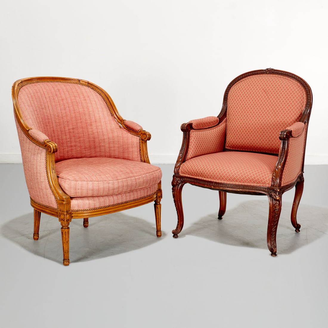 (2) Antique Louis XVI style bergeres: (2) Antique Louis XVI style bergeres, 19th/20th c., France, one with carved and channeled frame, scroll arms, nail head trim, loose down-filled cushion, 37"h x 29.5"w x 28"d, approx. 8.5"h (to seat);