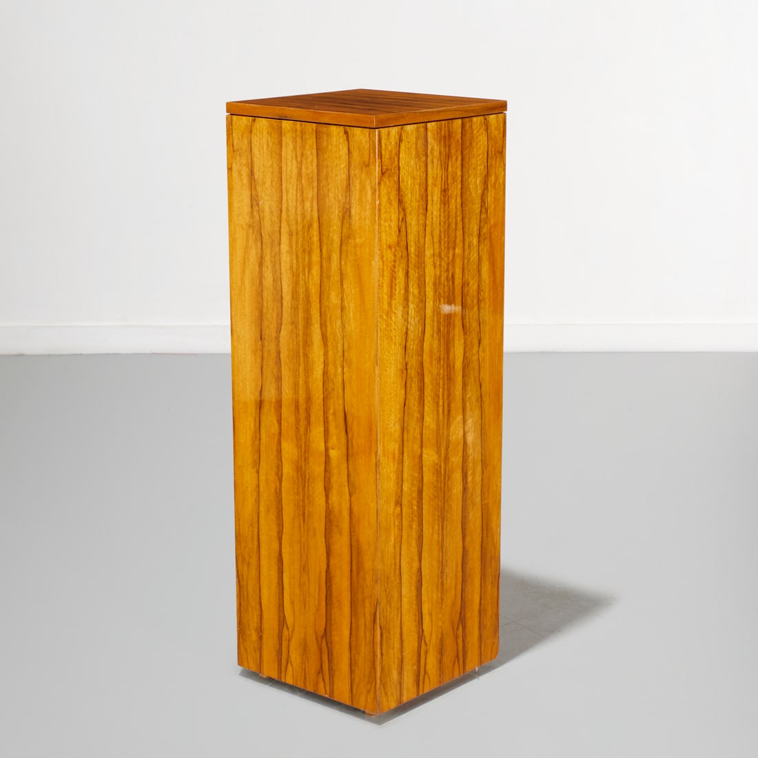 Modernist exotic wood display pedestal: Modernist exotic wood display pedestal, 20th c., with rotating top, 43"h x 14"squ