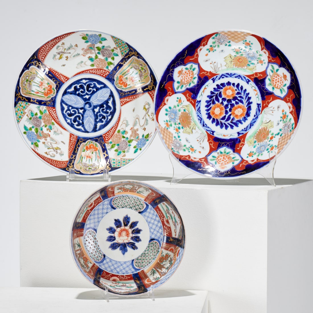 Japanese Imari porcelains group: Japanese Imari porcelains group, 19th/20th c., incl. (2) similar chargers, and a footed bowl, each unmarked, bowl with inscribed sticker "Five color Japanese Imari, 1860", 13.5"dia (chargers), 4"h x 9