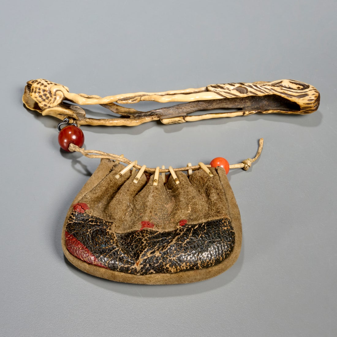 Antique Japanese tobako-ire, ojime and netsuke: Antique Japanese tobako-ire, ojime and netsuke, Edo or Meiji Period (Japan, 19th c., or earlier), carved and polished bone netsuke in the form of a long-stemmed plant, possibly a pipe holder, glass oj