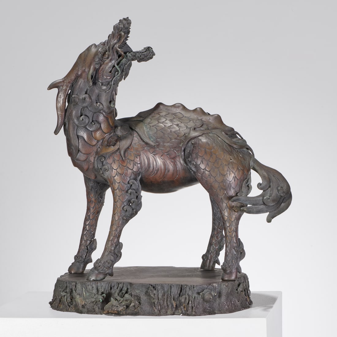 Large antique Japanese patinated bronze Kirin: Large antique Japanese patinated bronze Kirin, Meiji Period (19th/20th c.), cast in an animated pose, on naturalistic base, unmarked, 26"h x 21"l x 13"d Provenance: A Private Collection: 22 Partridge