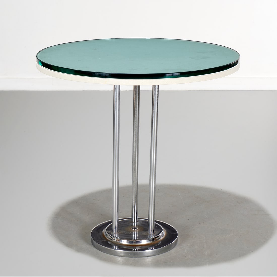 Wolfgang Hoffman (style) glass top side table: Wolfgang Hoffman (style) glass top side table, 20th c., raised on tripod chromed base, 29.5"h x 29.5"dia
