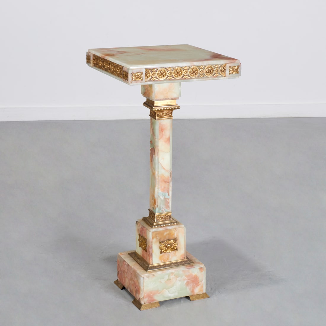 Napoleon III bronze mounted onyx pedestal: Napoleon III bronze mounted onyx pedestal, 19th/20th c., square top with guilloche and rosette trim, over square column, on stepped base with bracket feet, unmarked, 35"h x 16"squ Provenance: A