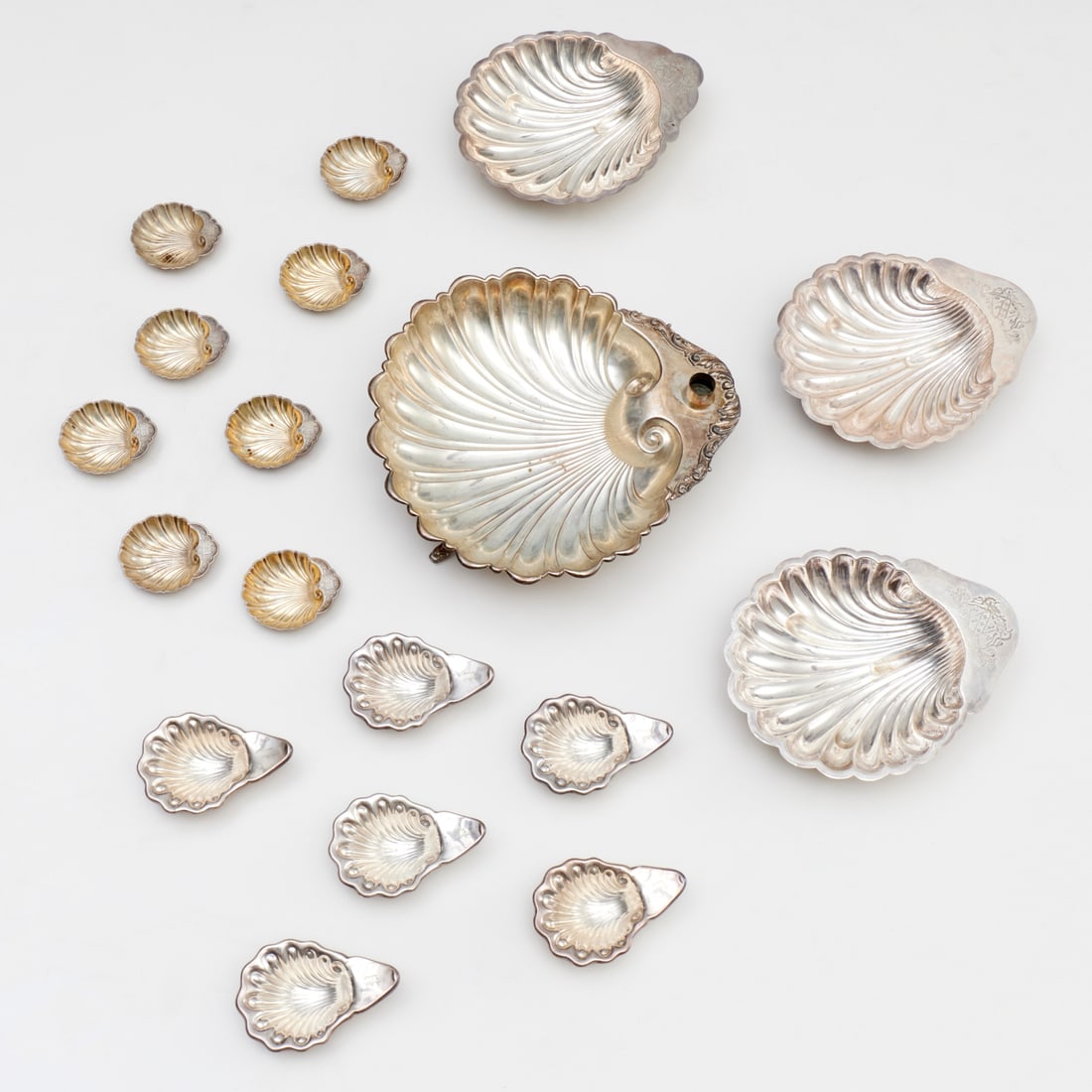 Group silver plated clam shell serving dishes: Group silver plated clam shell serving dishes, 20th c., (18) pieces, incl. a shrimp cocktail server marked "Crescent", set (6) Gorham small footed shell butter dishes, monogrammed, pair English servin