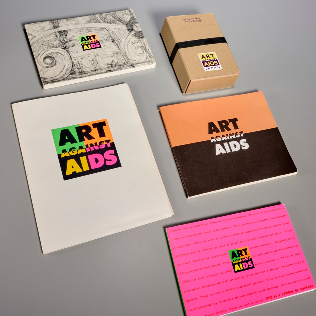 Art Against AIDS, (4) exhibition catalogues: Art Against AIDS, (4) exhibition catalogues, Incl. 1) Art Against AIDS Japan: The Artist's Camera, 1994, complete in original box; 2) San Francisco, 1989; 3) Washington D.C., 1990; 3) New York City, 1