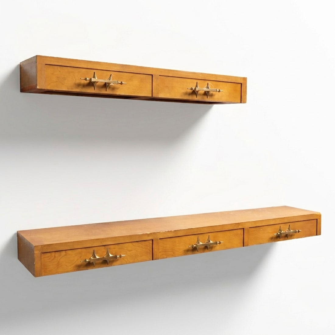 (2) MCM wall mounted consoles: (2) MCM wall mounted consoles, Mid 20th c., with distinctive brass hardware, unmarked, 6"h x 78.25"w x 12"d (larger), 6"h x 50.25"w x 12.25"d (smaller) Provenance: A Private Collection: 115 Central Pa