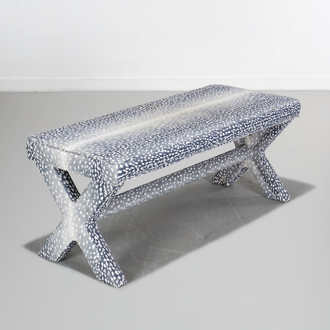 Michael Thomas, modern upholstered bench: Michael Thomas, modern upholstered bench, 21st c., fully upholstered in animal print, on X-form legs with stretcher, labeled on underside, 19.75"h x 48"w x 20"d Provenance: The Collection of June and