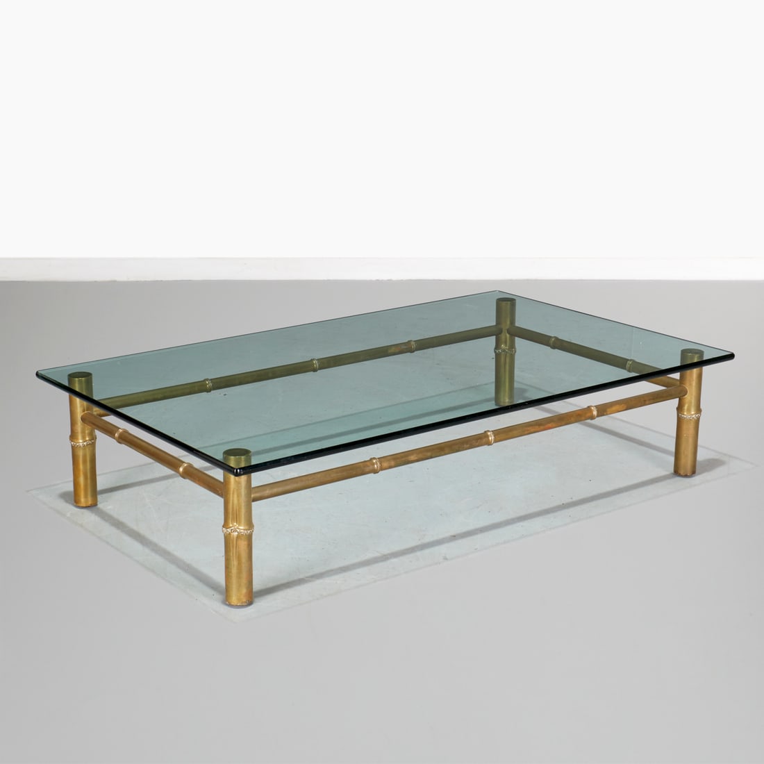 T.H. Robsjohn-Gibbings, brass coffee table: T.H. Robsjohn-Gibbings, brass coffee table, c. 1953, USA, faux bois bamboo frame, lacking glass, unmarked, 13.5"h x 60"w x 36"d Provenance: Commissioned for Kandell Residence, Ritz-Carlton, NYC