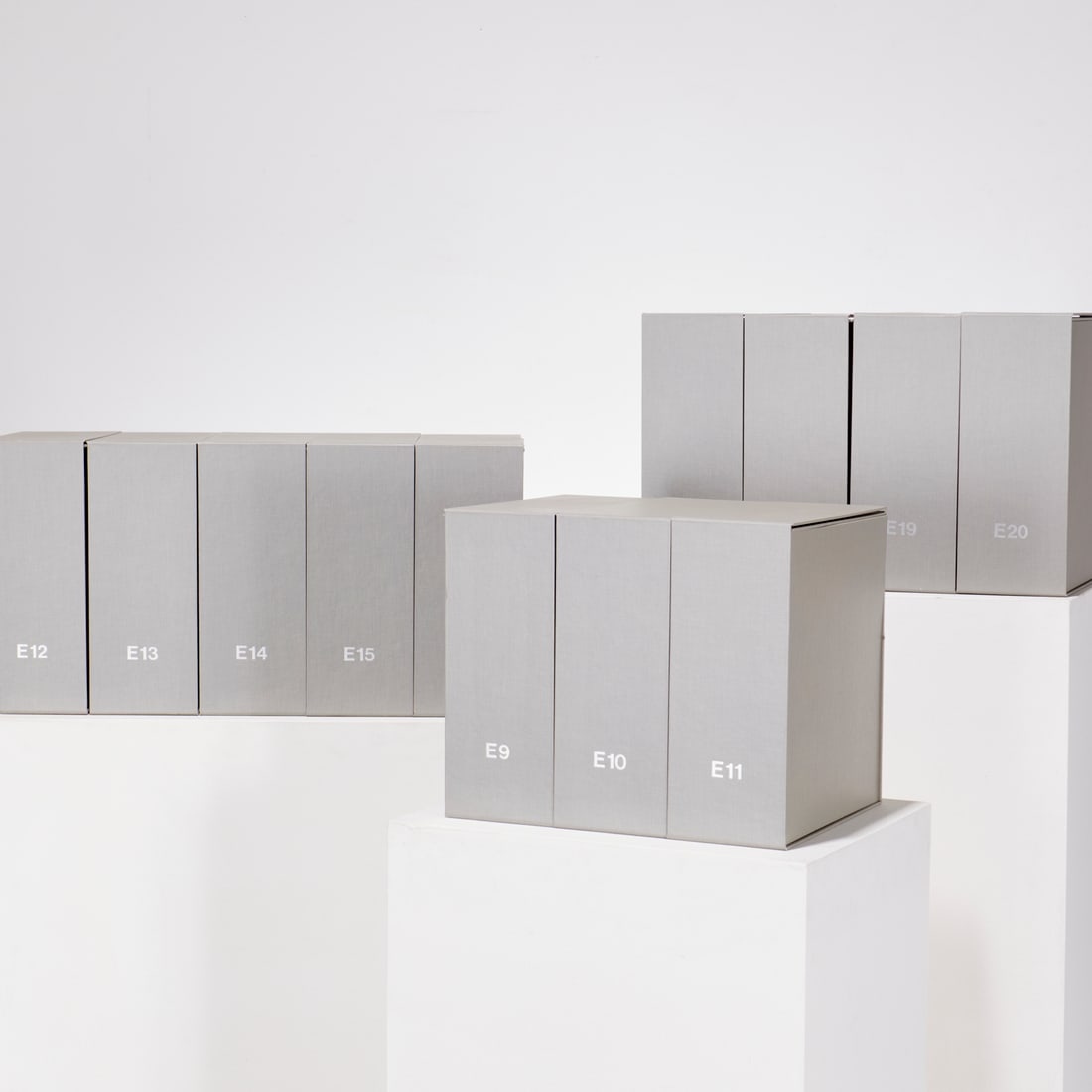 (12) Library-quality book or document boxes: (12) Library-quality book or document boxes, Covered in light grey, coated cloth, lined with white paper, two top flaps held closed with 4 Velcro buttons, one lid flap hinges down for easy access, box