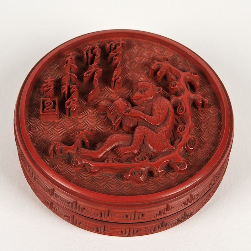 Small round Chinese cinnabar lacquer box: Small round Chinese cinnabar lacquer box, 19th c., with monkey eating peach, 0.75"h x 2.5"dia. Provenance: Descendants of the Otto Huber brewing family, NY