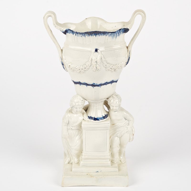 Rare Leeds pearlware urn-form spill vase: Rare Leeds pearlware urn-form spill vase, 18th/19th c., putti base, 9.5"h x 5.25"w x 3.25"d