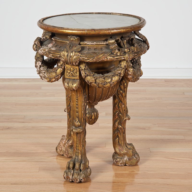 George II style carved giltwood pedestal: George II style carved giltwood pedestal, 19th c., circular top, laurel garlands, lion paw feet, 25"h x 18.5"dia.