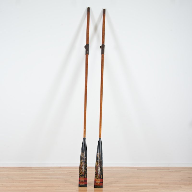 (2) C.C.C. Eight "Winning Blades" painted scull oars: (2) C.C.C. Eight "Winning Blades" painted scull oars, 1905 and 1906, trophy oars for Oxford University's intercollegiate rowing regatta, 140"l x 5.5"w Provenance: The Estate of actor Cliff Robertson,