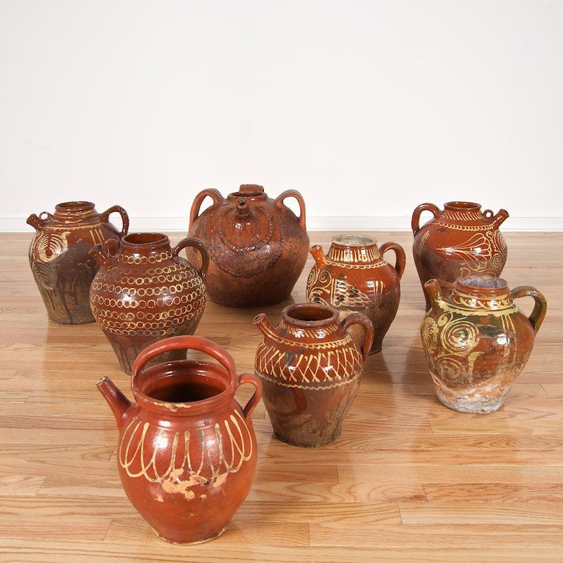 Collection (8) Mexican slip decorated redware oil jugs: Collection (8) Mexican slip decorated redware oil jugs, 19th/20th c., largest: 14.5"h x 16"dia., smallest: 11"h x 9.5"dia.