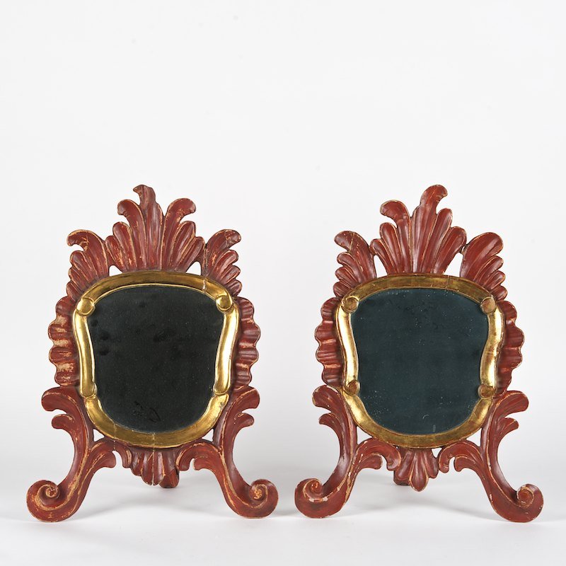 Pair Italian Rococo style red painted table mirrors: Pair Italian Rococo style red painted table mirrors, First half 20th c., gilt slip, foliate carved props, 19"h x 14"w