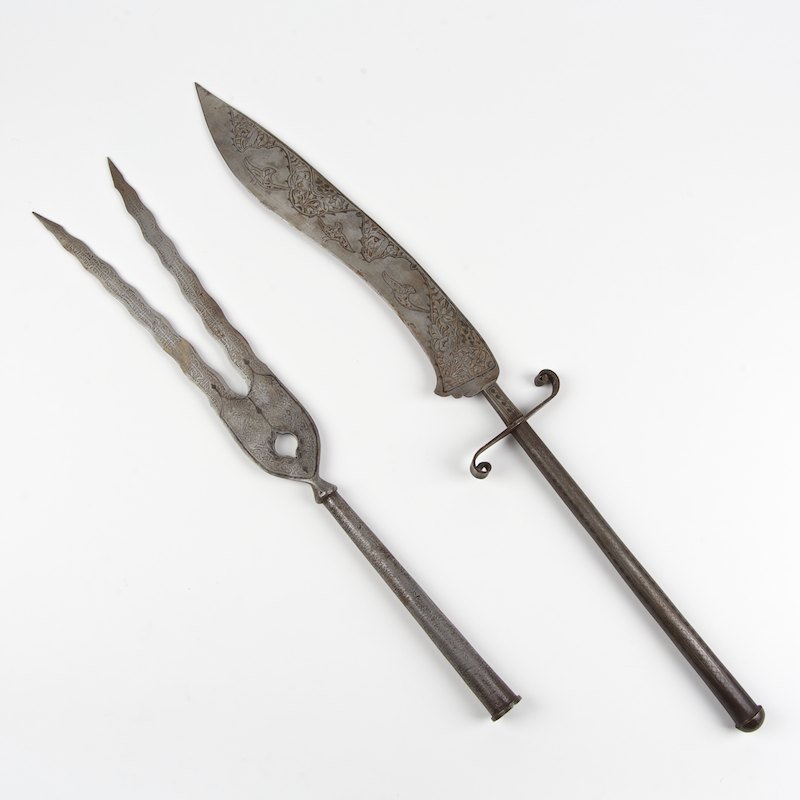 (2) Persian etched and niello steel edged weapons: (2) Persian etched and niello steel edged weapons, 19th/20th c., incl. a bifurcate spear head and a long handled sword, larger: 28"l x 4.5"w, smaller: 22.5"l x 3.5"w