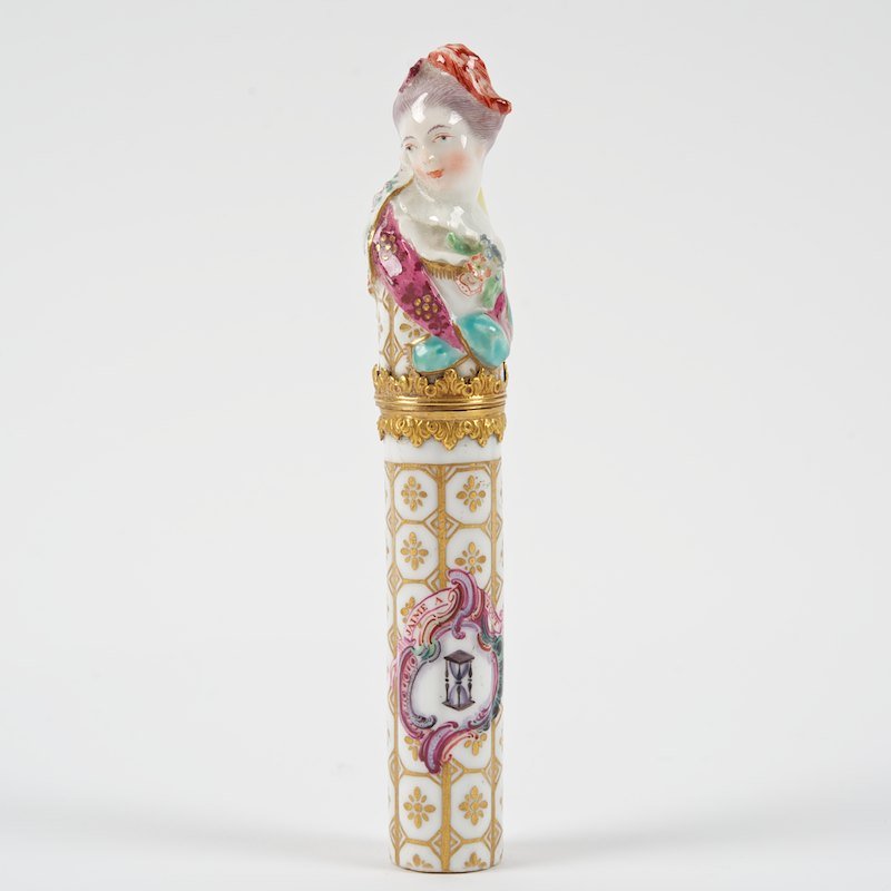Rare Chelsea porcelain figural needle case: Rare Chelsea porcelain figural needle case, 18th c., gilt bronze mounted, with motto "Jaime a Tout Heure", 5"l x 1"dia. Provenance: Rosenberg & Stiebel, Inc., NY: purchased May 22, 1961 for $250.00