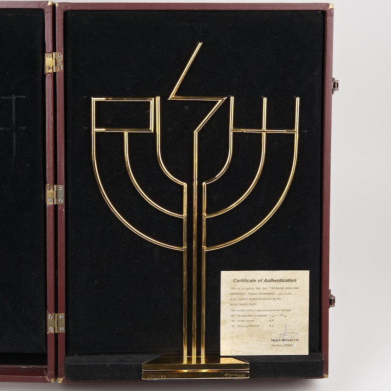 Yaacov Agam (1928, Israeli), Menorah: Yaacov Agam (1928, Israeli), Menorah, "Tri-Base Shalom Menorah", gilded metal, signed and numbered "Agam - 151/180", in original case, 17.5"h x 11.5"w