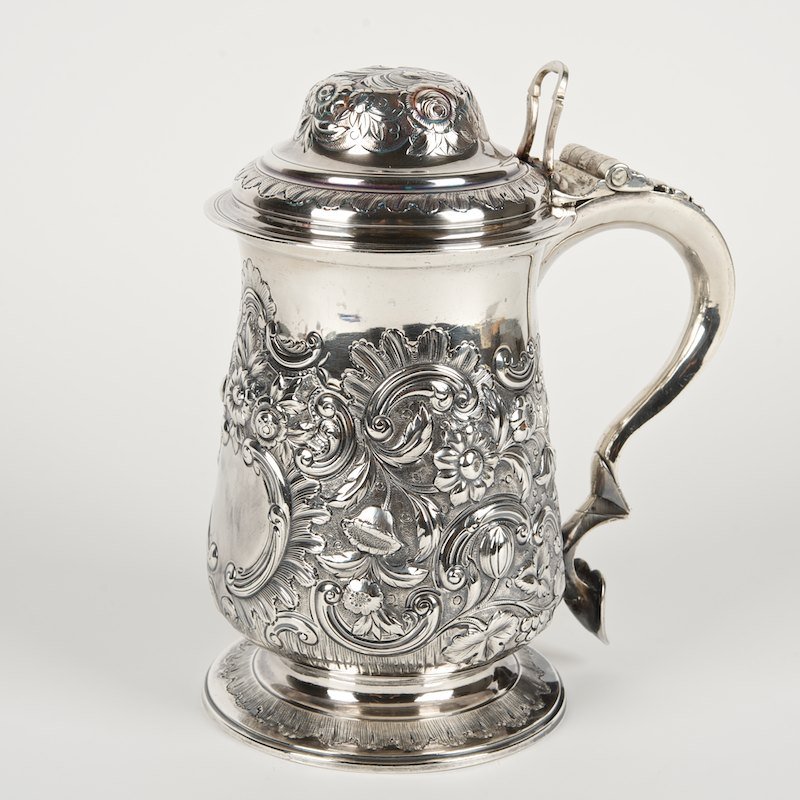 George III sterling silver tankard: George III sterling silver tankard, London, c. 1779, maker's mark probably that of John King, floral chased body and domed cover (marked with maker as well), 8.25"h x 7"w (over handle), approx. 28 ozt