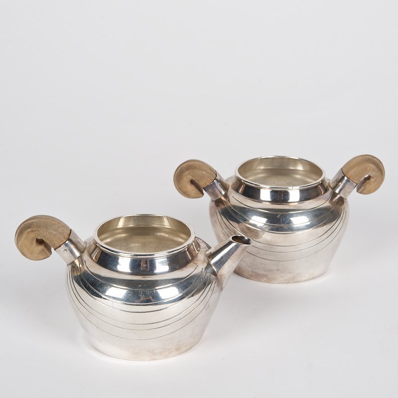William Spratling sterling silver creamer and sugar: William Spratling sterling silver creamer and sugar, 20th c., engraved line design, hallmarked, 3"h x 5.25"l (sugar), 2.75"h x 5.5"l (creamer), approx. 12.2 ozt.